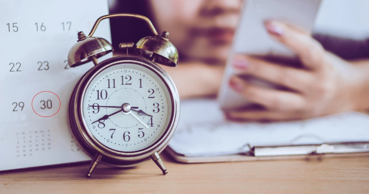 person distracted at desk procrastinating work